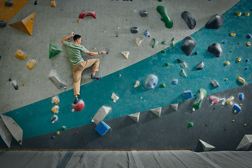 An Pham, a living-donor kidney transplant recipient, climbs a wall at a downtown L.A. rock climbing gym