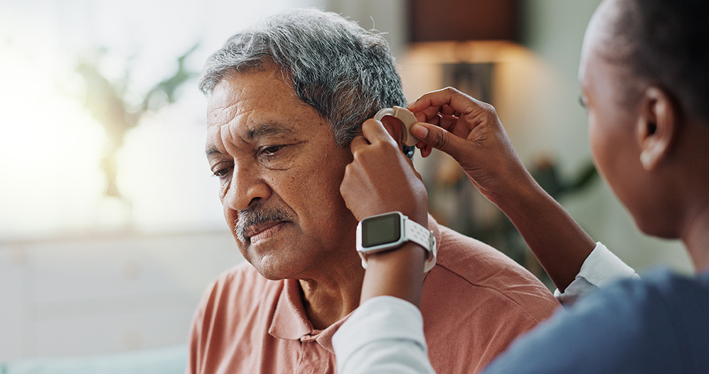 Man gets fitted for a hearing aid.