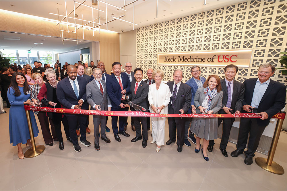 group of people cut a ribbon at ribbon-cutting ceremony for new building
